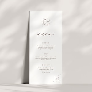 May include: A minimalist menu with a moon and stars design. The menu lists a starter, main course, and dessert. The starter is  "Mascul greens with wine ripened tomatoes & fresh mozzarella, & aged balsamic vinaigrette". The main course is "Porcini crusted chilean sea bass with fingerling potatoes & wild mushrooms, red wine reduction". The dessert is "Vanilla sake with strawberries and whipped cream filling".
