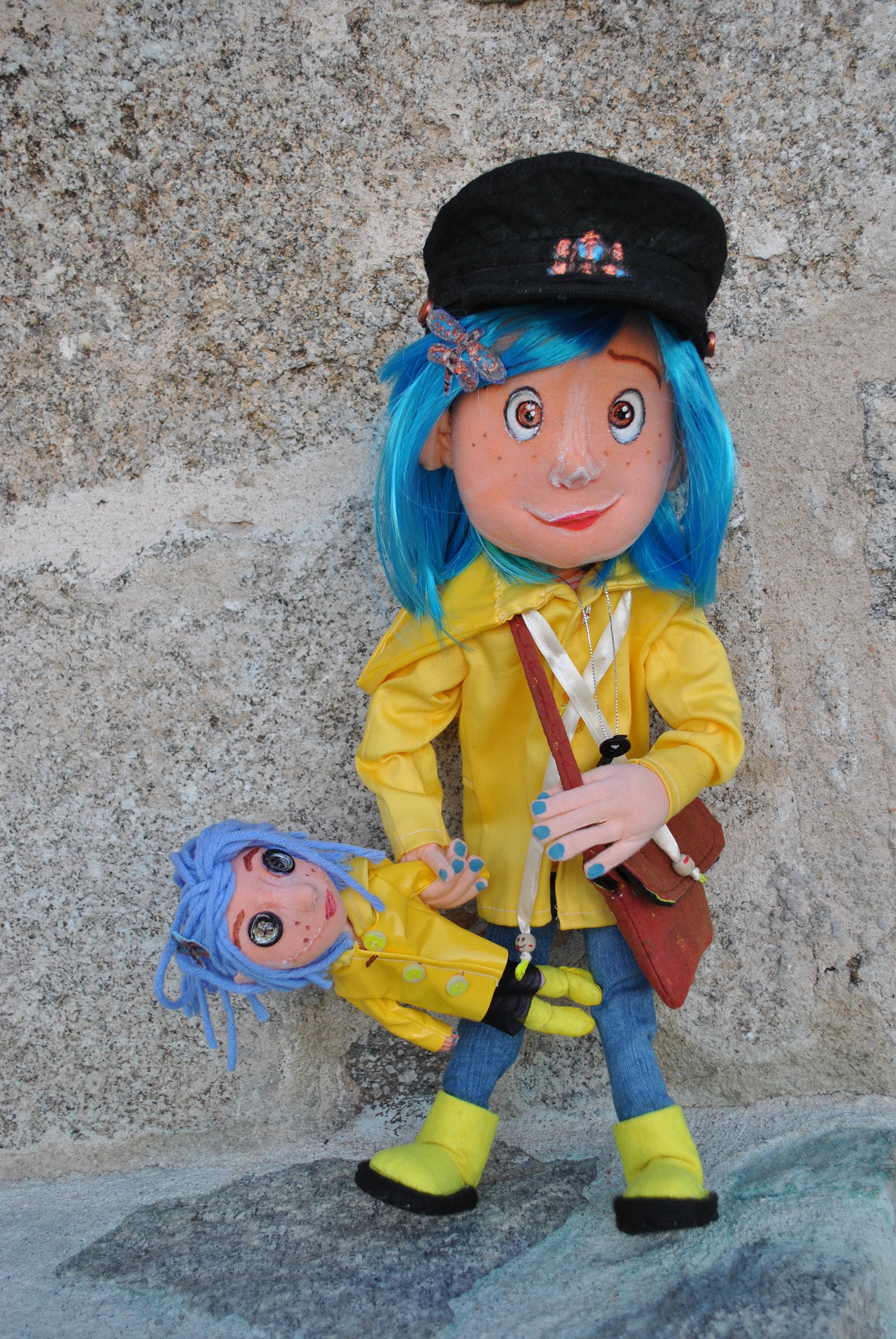 2 Coraline fabric dolls: blue hair and small coraline doll with buttoned eyes and stitched mouth, with yellow raincoat, together, to play