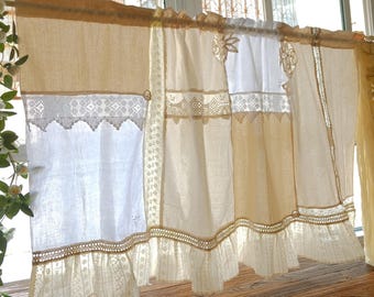 May include: Cream-colored and white lace curtains with a ruffled bottom edge. The curtains are made of a light, airy fabric and are decorated with intricate lace and embroidery details. The curtains are hanging on a wooden rod.
