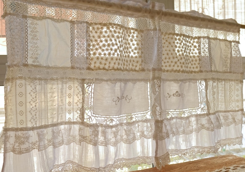Puede incluir: Cortinas blancas de encaje con un dise&ntilde;o de patchwork. Las cortinas est&aacute;n hechas de diferentes tipos de encaje, incluyendo encaje de ganchillo y encaje bordado. Las cortinas est&aacute;n colgadas en una ventana y dejan entrar la luz natural.
