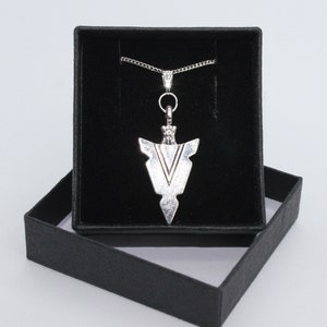 May include: Silver arrowhead pendant necklace in a black velvet jewellery box.