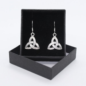 May include: A pair of silver Celtic knot earrings in a black box. The earrings are in the shape of a triangle with a knot design.