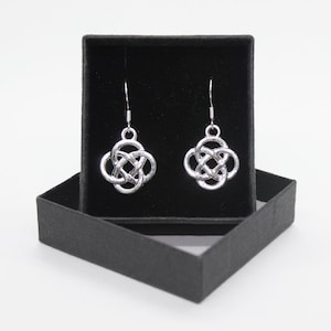 May include: A pair of silver Celtic knot earrings in a black velvet jewellery box.