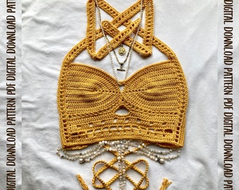 May include: A crochet bralette pattern, called "The Phoebe Bralette", in a yellow color. The pattern is available as a digital download from Lizard&Hook.