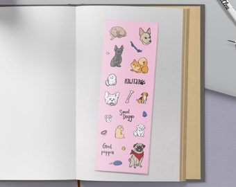 May include: A pink sticker sheet with illustrations of dogs. The stickers feature various dog breeds, including a pug, a chihuahua, a terrier, and a poodle. The stickers also include phrases like "Good pup", "Small Doggo", and "Pawsitive".