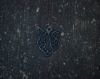 May include: A geometric metal pendant in the shape of a cat's face. The pendant is a dark blue color and has a hole at the top for a chain.