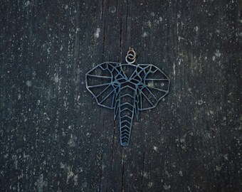 May include: A geometric metal elephant pendant with a black finish. The pendant is hanging from a wooden surface.
