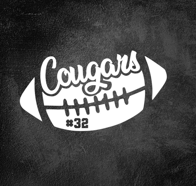 May include: White silhouette of an American football with the word "Cougars" in a stylized font and the number "#32" on the side. The image is on a black textured background.