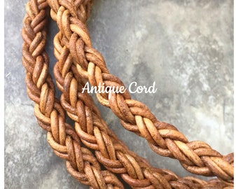 May include: Close-up of a braided leather cord in a light brown color. The cord is woven in a tight, intricate pattern. The text "Antique Cord" appears twice in the image.