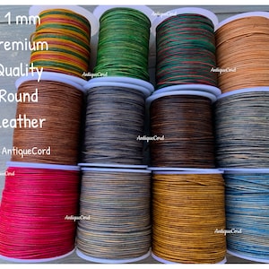 May include: Spools of 1 mm round leather cord in various colors, including red, brown, green, and blue. The text on the image reads "1 mm Premium Quality Round Leather by AntiqueCord."