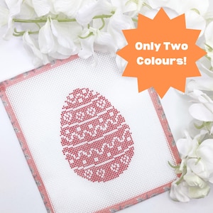 Puede incluir: Un lienzo blanco con un borde rosa, que presenta un diseño de huevo de Pascua con estampado rojo y blanco. El texto "Only Two Colours!" está escrito en naranja sobre una forma de estrella.