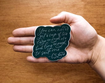 May include: A dark green sticker with a white quote from C.S. Lewis that reads "You can never get a cup of tea large enough or a book long enough to suit me - C.S. Lewis".