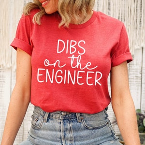 May include: Red t-shirt with white text that reads "DIBS on the ENGINEER".