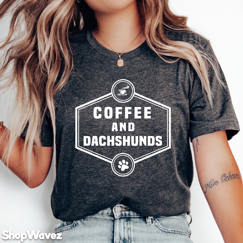 May include: A gray t-shirt with a white graphic that says "Coffee and Dachshunds" with a coffee cup and paw print.
