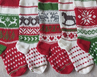 May include: Five knitted Christmas stockings with different patterns. The stockings are red, white, and green with various designs including reindeer, gingerbread men, snowflakes, and a rocking horse.
