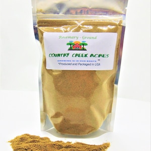 May include: A resealable bag of ground rosemary spice. The bag is labeled "Rosemary - Ground" and "COUNTRY CREEK ACRES". The label also says "GROWING IS IN OUR ROOTS" and "*Produced and Packaged in USA".