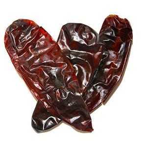 May include: Three dried red chili peppers, with a dark, almost black, sheen. The peppers are arranged in a heart shape.