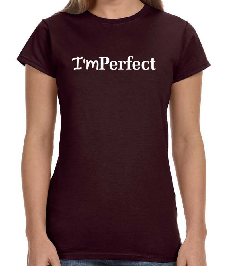 May include: A maroon t-shirt with the text "I'm Perfect" in white.