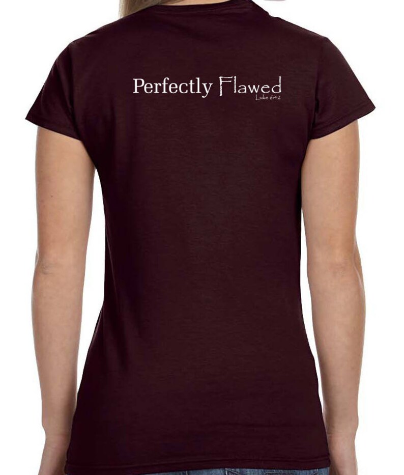 May include: A maroon t-shirt with the text "Perfectly Flawed" and "Luke 6:42" printed on the back.