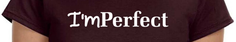 May include: A maroon t-shirt with the text "I'mPerfect" printed in white.