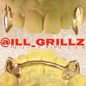 May include: Gold grillz with a curved bar design. The grillz are shown in a mouth mold. The text "@ILL_GRILLZ" is written in red letters with dripping red paint.