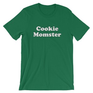 May include: A green t-shirt with the text "Cookie Momster" in white.
