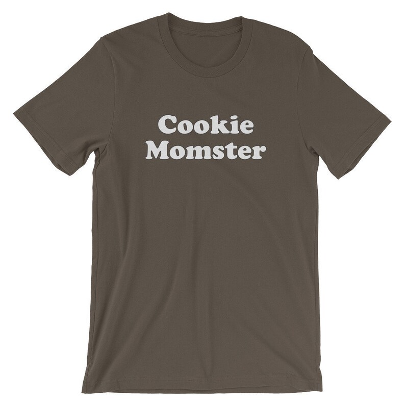May include: A dark brown t-shirt with the text "Cookie Momster" printed in white.