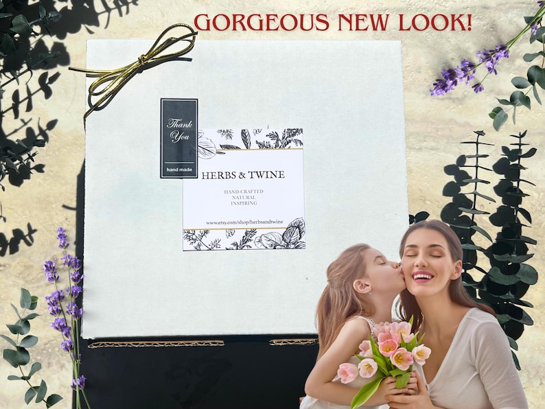 May include: A white box with a gold ribbon, a label that reads "HERBS & TWINE", and the text "GORGEOUS NEW LOOK!". A woman and a child are in the foreground, with the child kissing the woman's cheek. The woman is holding a bouquet of pink flowers.