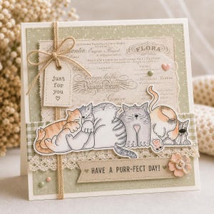May include: A handmade greeting card with a cream-colored base. The card features a decorative design with a watercolor illustration of five cartoon cats. The text "just for you" and "Have a purr-fect day!" are included.