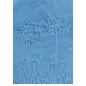 May include: A light blue embossed paper featuring a dandelion design. Two large dandelions are in the background, with smaller ones and blades of grass in the foreground. The image has a textured appearance.