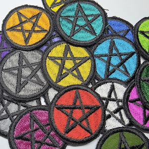 May include: A selection of embroidered patches, each with a black pentagram design inside a circle. The patches are in various colours, such as yellow, red, green, blue, and purple, with a black border. Suitable for clothing or accessories.