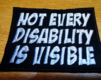 May include: Black fabric patch with white embroidered text that reads "Not every disability is visible".