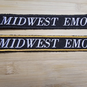 May include: Two black fabric patches with gold trim. Both patches have white text that reads "MIDWEST EMO".