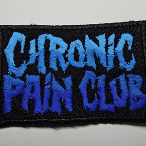 May include: A blue and black embroidered patch with the text "Chronic Pain Club".