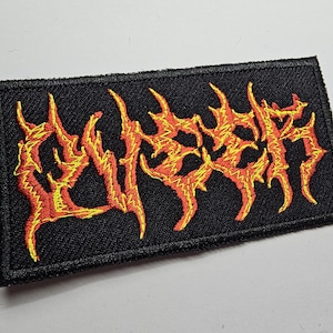 May include: Black embroidered patch with the word "LYMPH" in yellow and red flames.