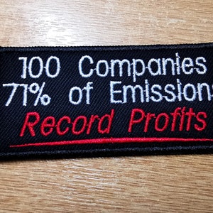 May include: Black embroidered patch with white text that reads "100 Companies 71% of Emissions Record Profits" with a red underline.