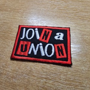 May include: Red and white embroidered patch with the text "Join a Union" on a black background.