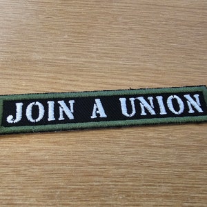 May include: A black and green embroidered patch with white text that reads "JOIN A UNION".