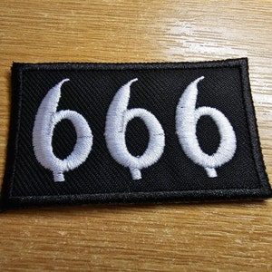 May include: A black fabric patch with white embroidered numbers "666" on a black background.