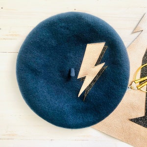 Petrol blue wool beret with appliquéd faux leather and glitter lightning bolt, pin-up style,50s style, ziggy stardust.