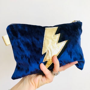 Blue Velvet clutch/makeup bag with gold leather lightning bolt. Appliquéd with Ziggy Stardust lightning bolt. Handmade to order.