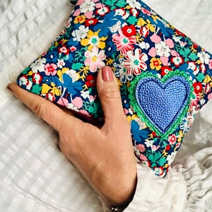 Liberty print quilted and heart appliquéd makeup bag. Lips makeup bag with faux leather on reverse. Made in the UK.