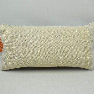 May include: A white rectangular cushion with a subtle woven texture. The cushion has a light blue border.