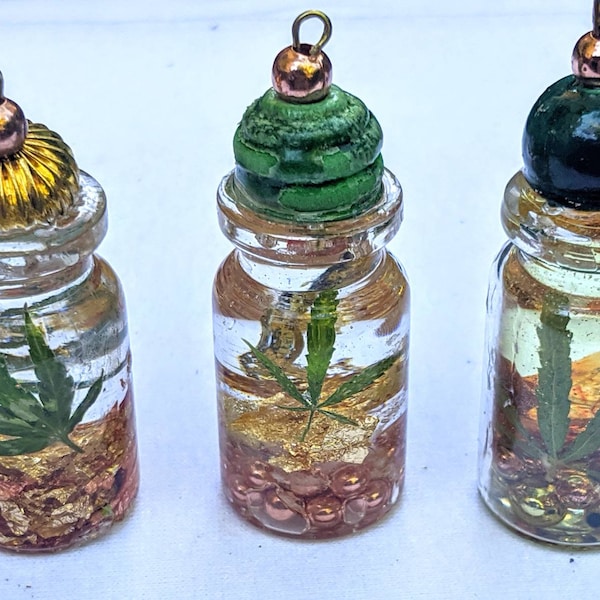 Real marijuana leaf 14kt gold leaf orgonite in a bottle