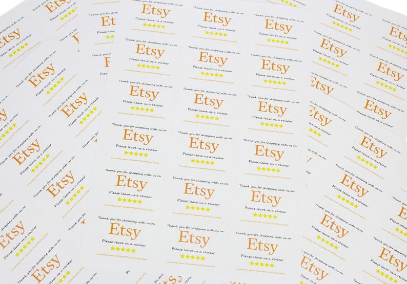May include: A stack of white thank you cards with the text "Etsy" in orange and five yellow stars. The text "Thank you for shopping with us on Etsy. Please leave us a review." is printed on the cards.