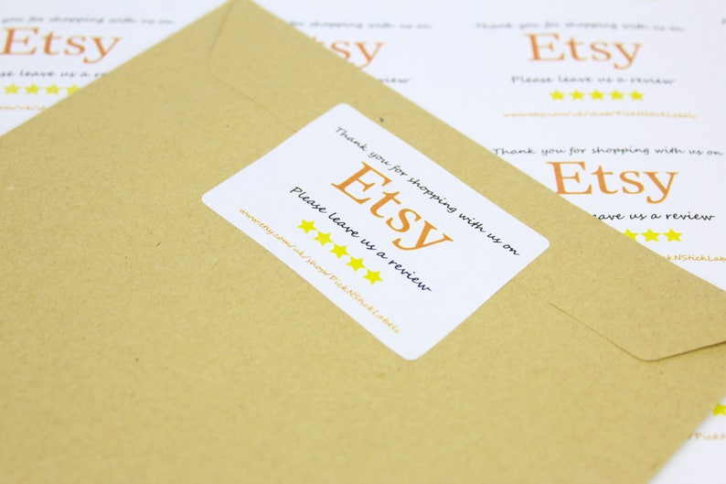 May include: A white sticker with the text "Thank you for shopping with us on Etsy. Please leave us a review." and five yellow stars. The sticker is on a brown paper envelope.