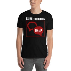 May include: Black t-shirt with white text that reads "Cure Tourettes" and a red graphic of two speech bubbles with the text "!@#*" inside one of the bubbles.
