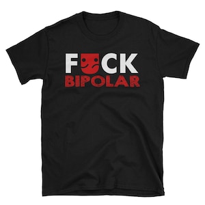 May include: Black t-shirt with white text that reads "FUCK BIPOLAR" with a red face emoji in the middle of the word "FUCK".