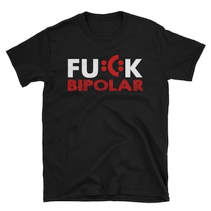 May include: Black t-shirt with the text "FU:CK BIPOLAR" in white and red. The word "FU" and the letter "K" are white, while the "U" is replaced with a red smiley face. The word "BIPOLAR" is in red.