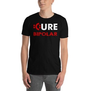 May include: Black t-shirt with white text that reads "CURE BIPOLAR" in a distressed font. The "C" in "CURE" is replaced with a red colon.